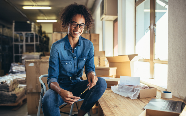 a person sitting a chair at a wooden desk