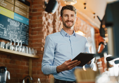A man holding a clip board and smiling
